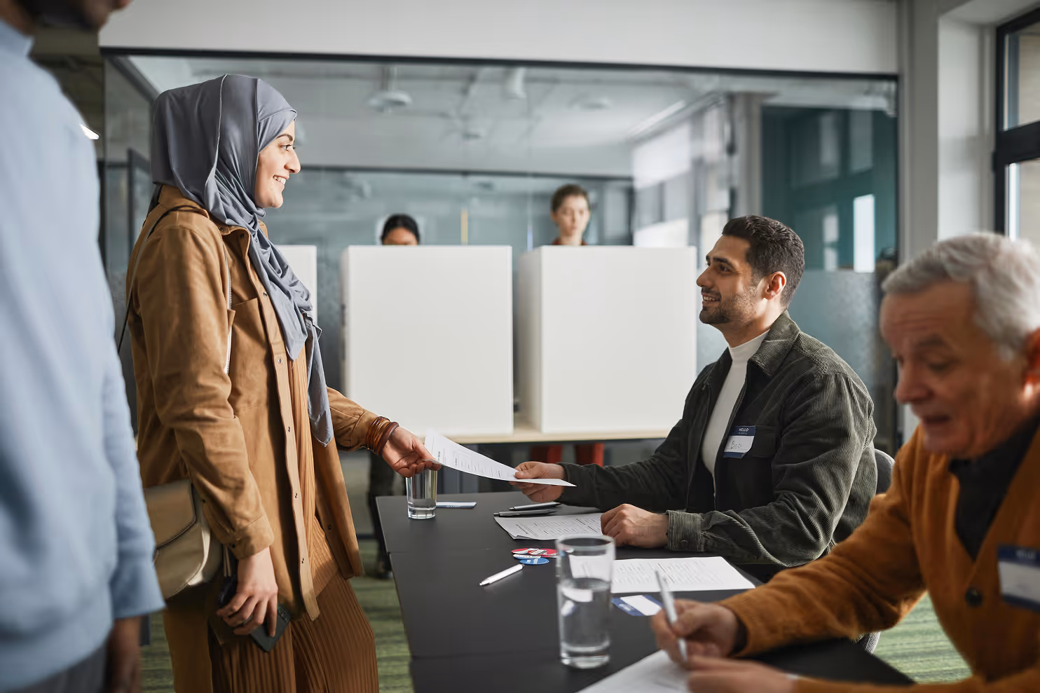 Mix of people in a reception area following a formal process