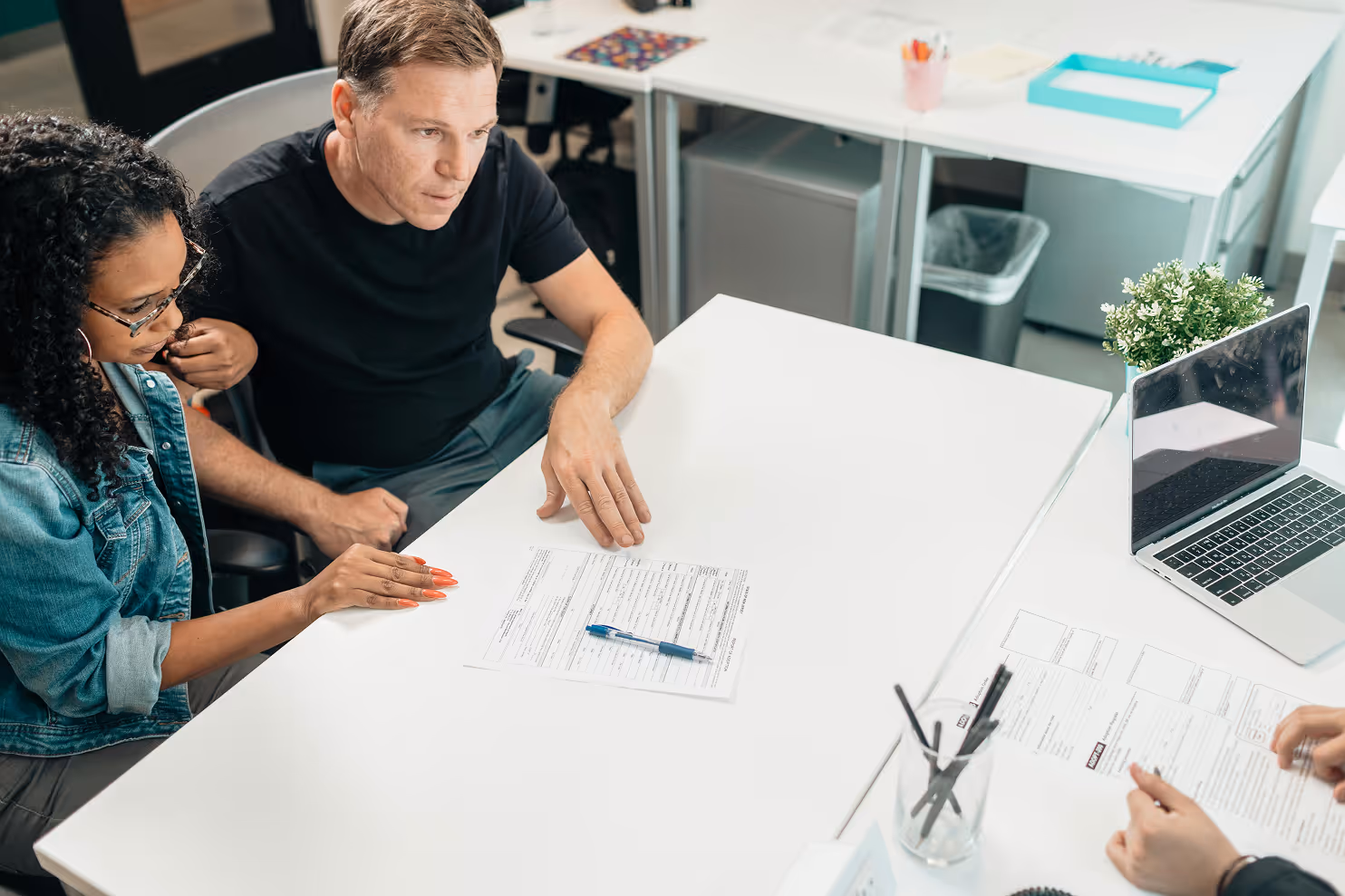 Couple sitting at a desk working with a consultant